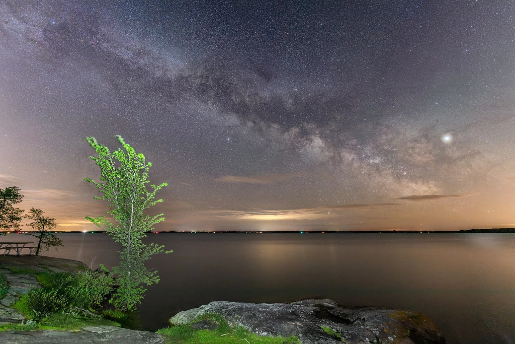 The Milky Way arcing over the Saint Lawrence River at night