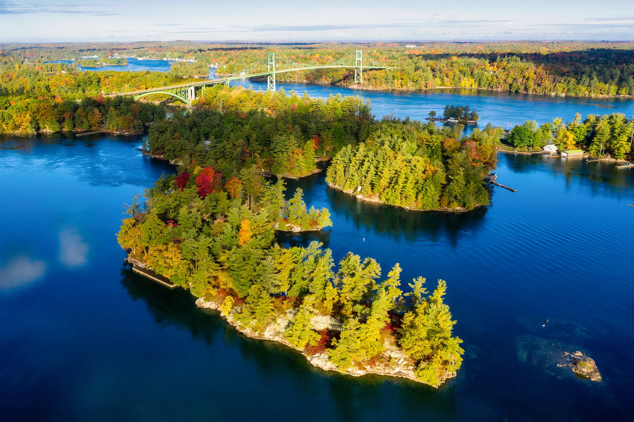 Aerial view of a bridge and forested islands in a river, showing the relationship between elements from a high viewpoint