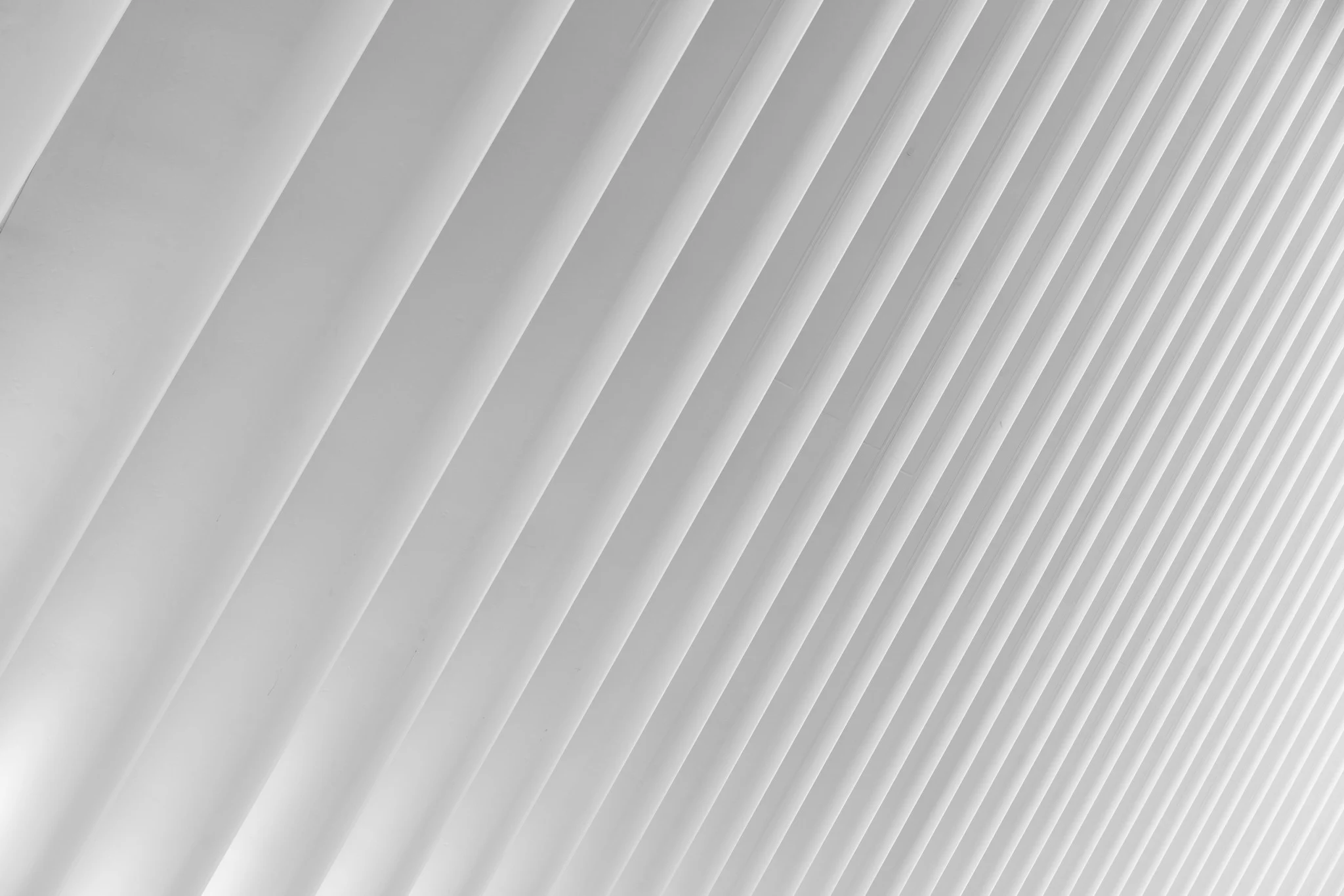 Repeating diagonal architectural ribs creating a rhythmic pattern of parallel lines and shadows