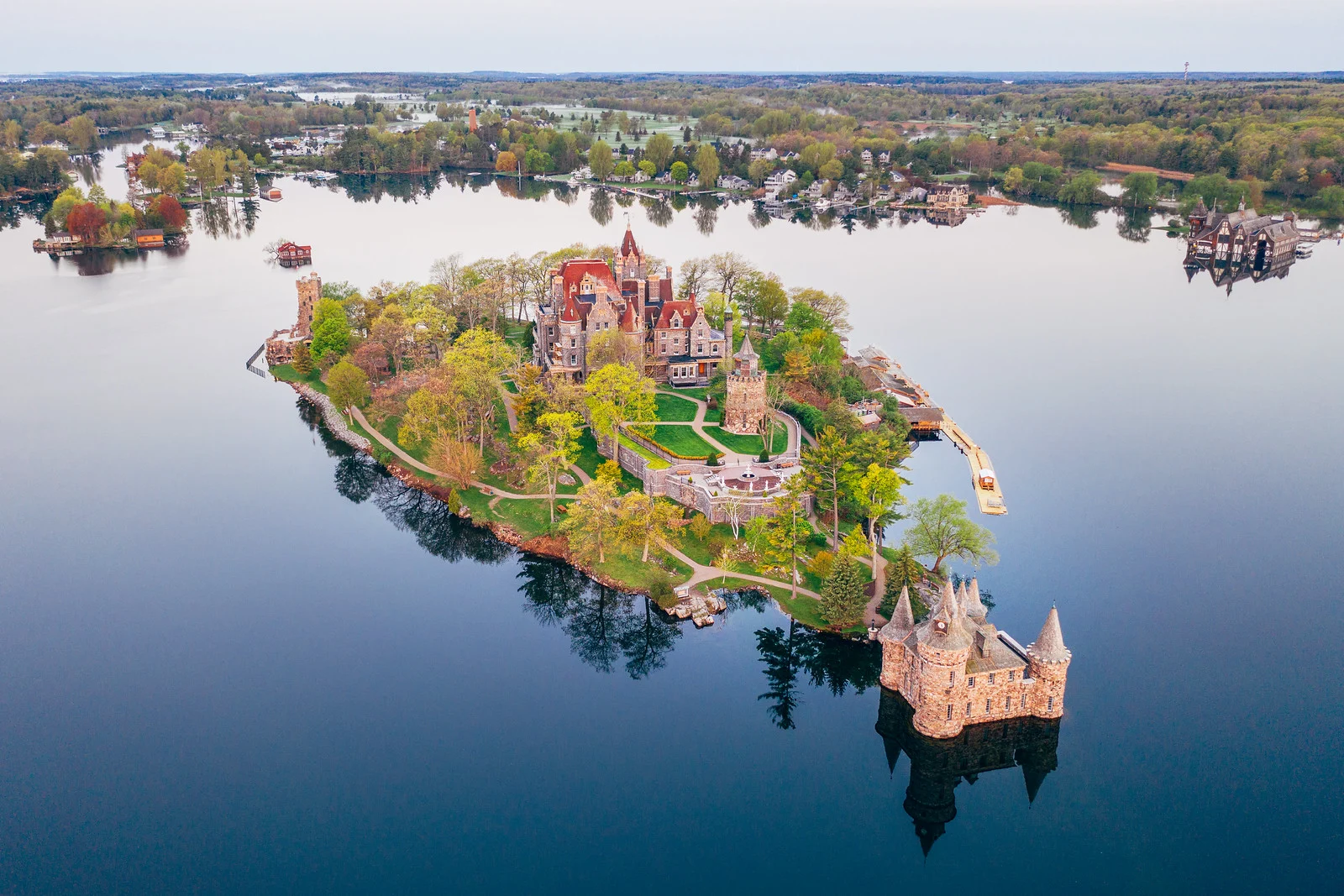 Aerial view of a small island estate surrounded by calm water, used as an example of a strong opening image