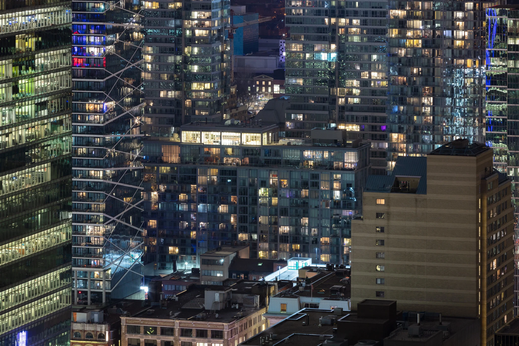 A dense cluster of Toronto condo towers photographed at 200mm, the long lens compressing the buildings tightly together