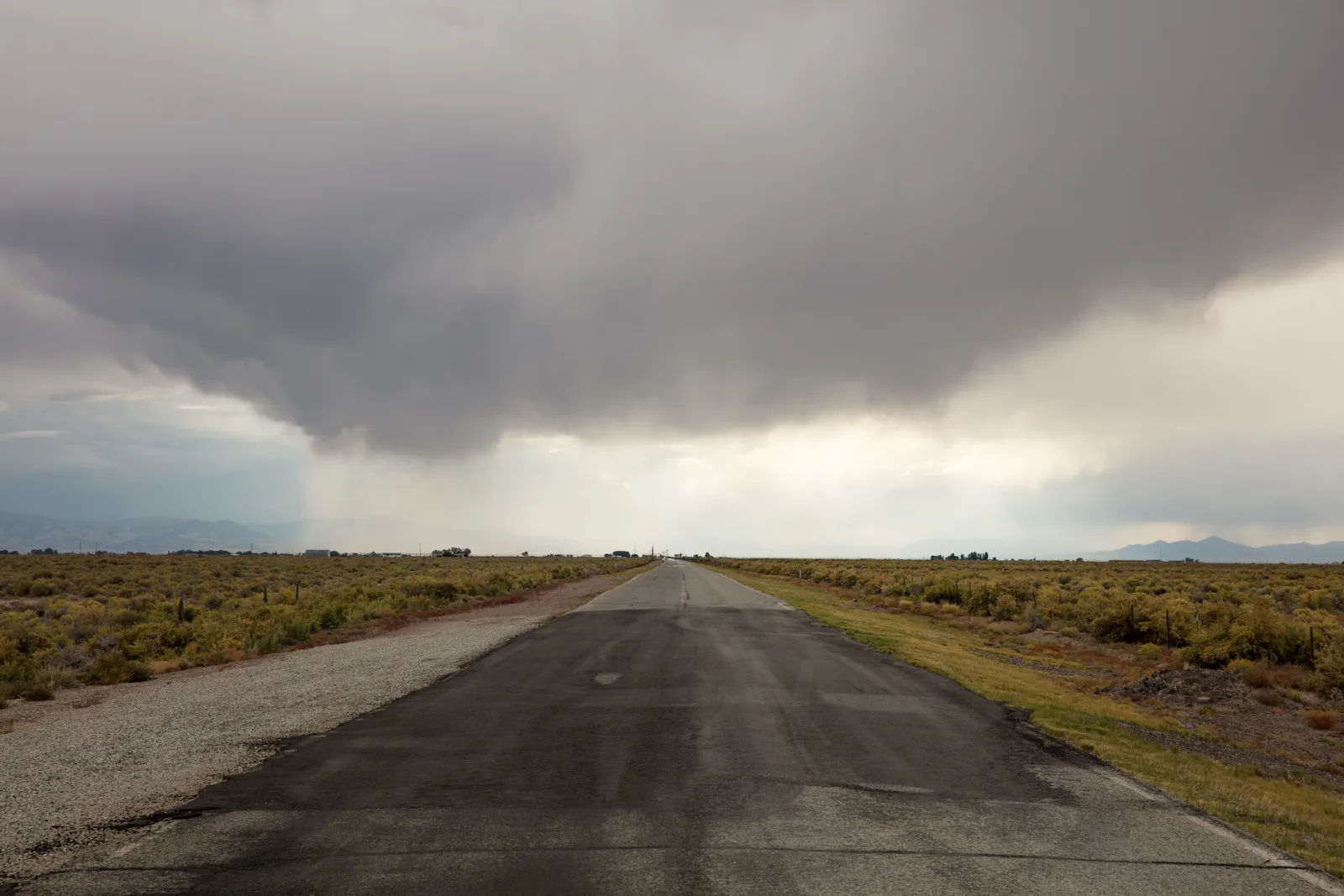 An empty road running to the horizon under a wide sky, photographed on a road trip